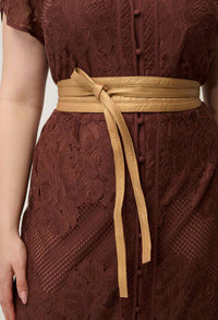 Detail of the front button fastening on the OnceWas Solene lace dress in Rosewood