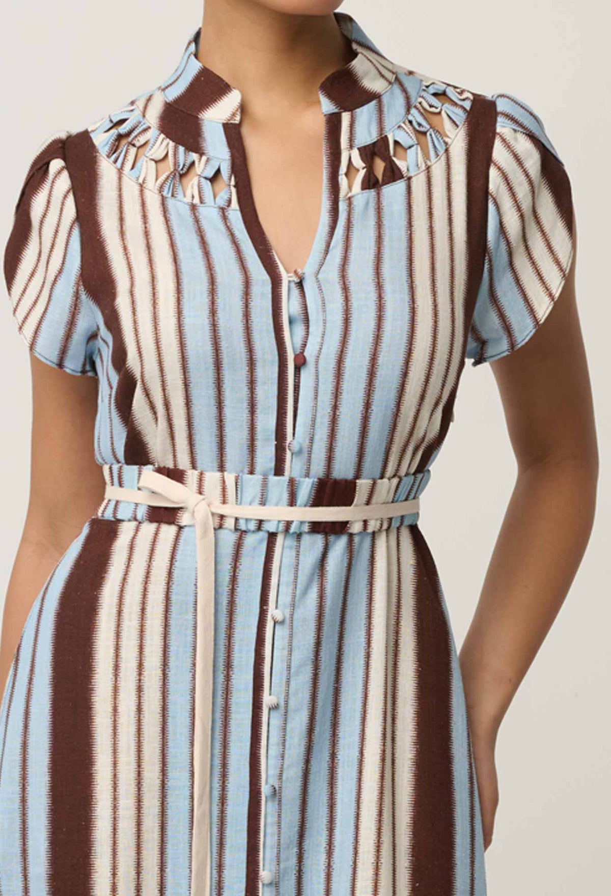 Close-up of the hand-smocked detail on the OnceWas Cattleya dress in Iridescent Stripe
