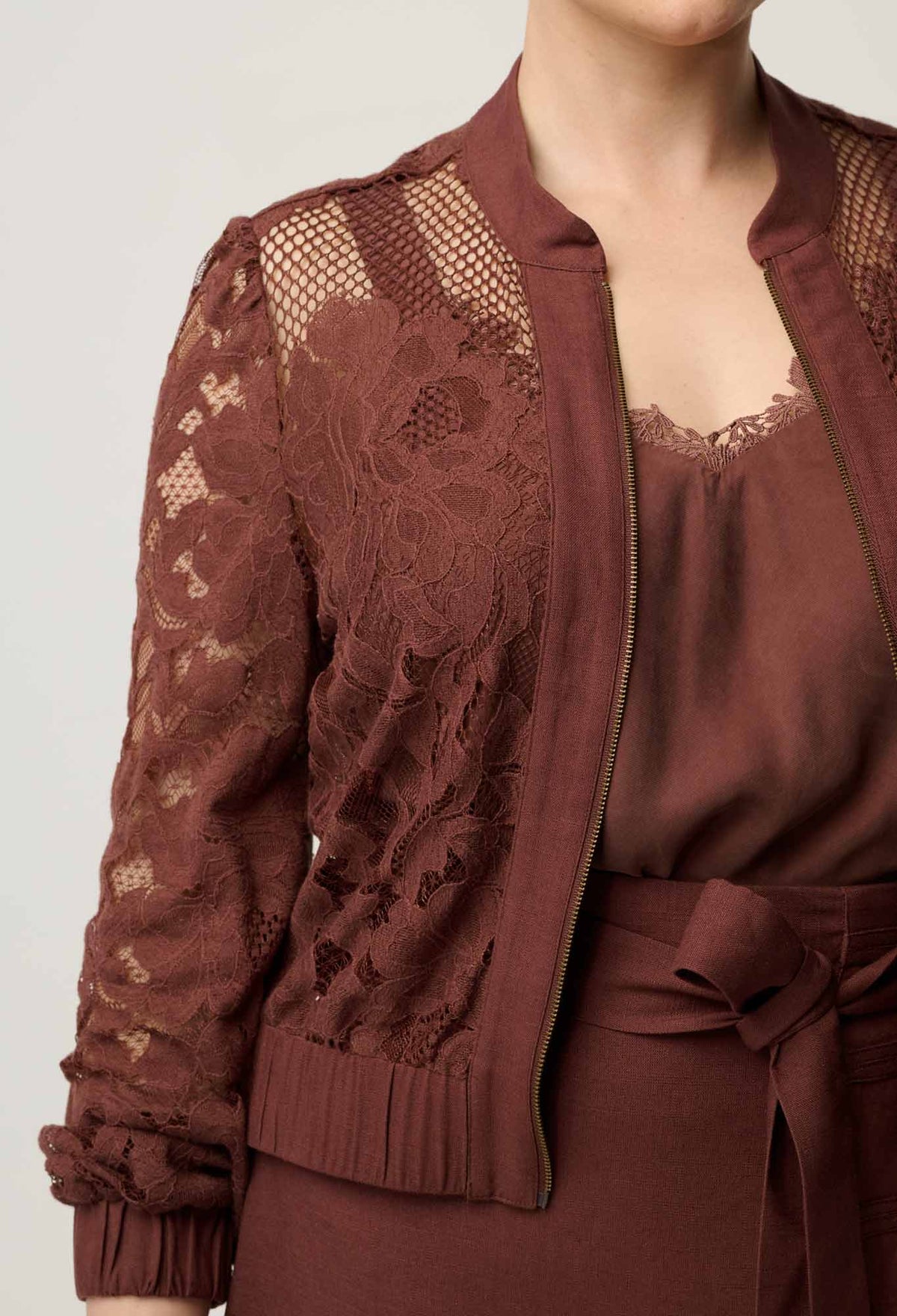 Close-up of the placement lace and linen trim on the OnceWas Solene bomber in Rosewood